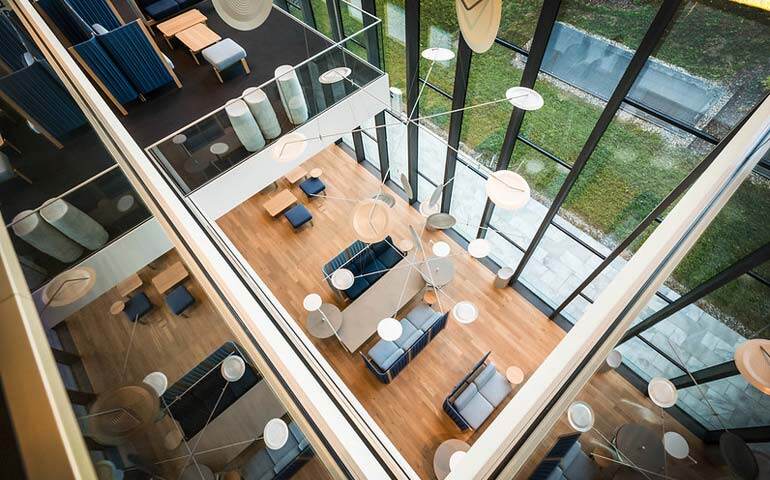 A spacious atrium featuring natural light and greenery
